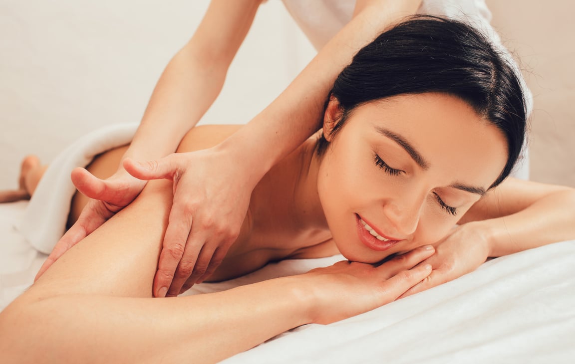 Beautiful mixed race woman enjoying a body massage, Ayurvedic massage using aroma oils. Thai body massage, aroma relaxation